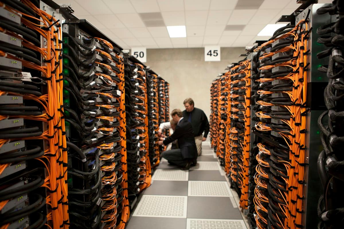 Engineers working between rows of servers in a data centre