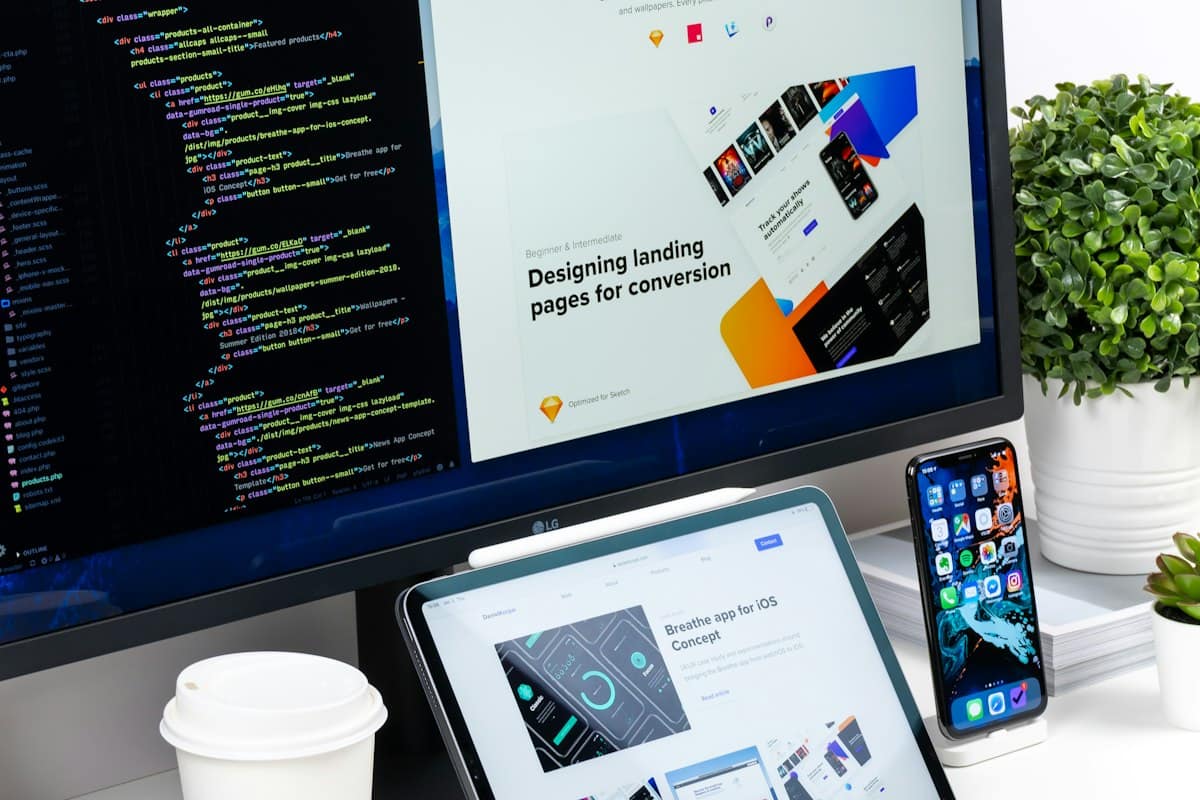 A desktop screen showing landing page designs next to a tablet and a phone