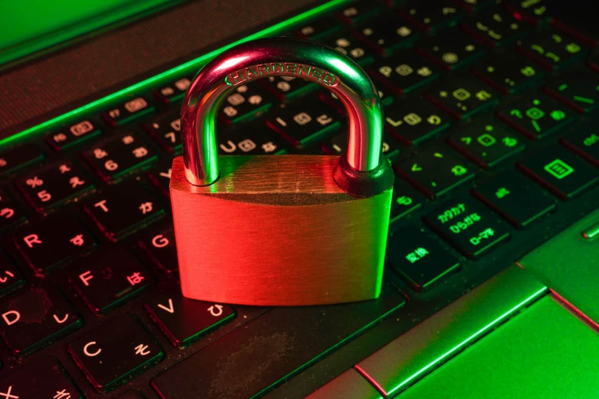A padlock resting on a laptop keyboard, representing application security